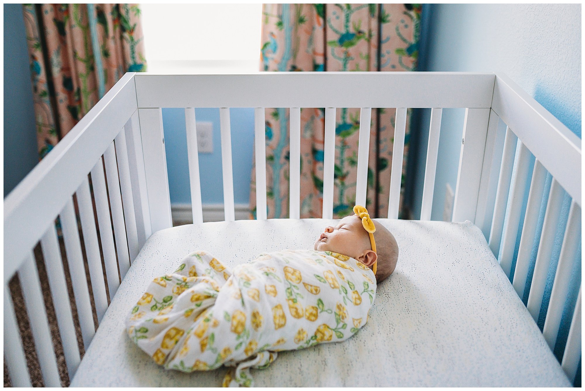newborn baby girl asleep in crib