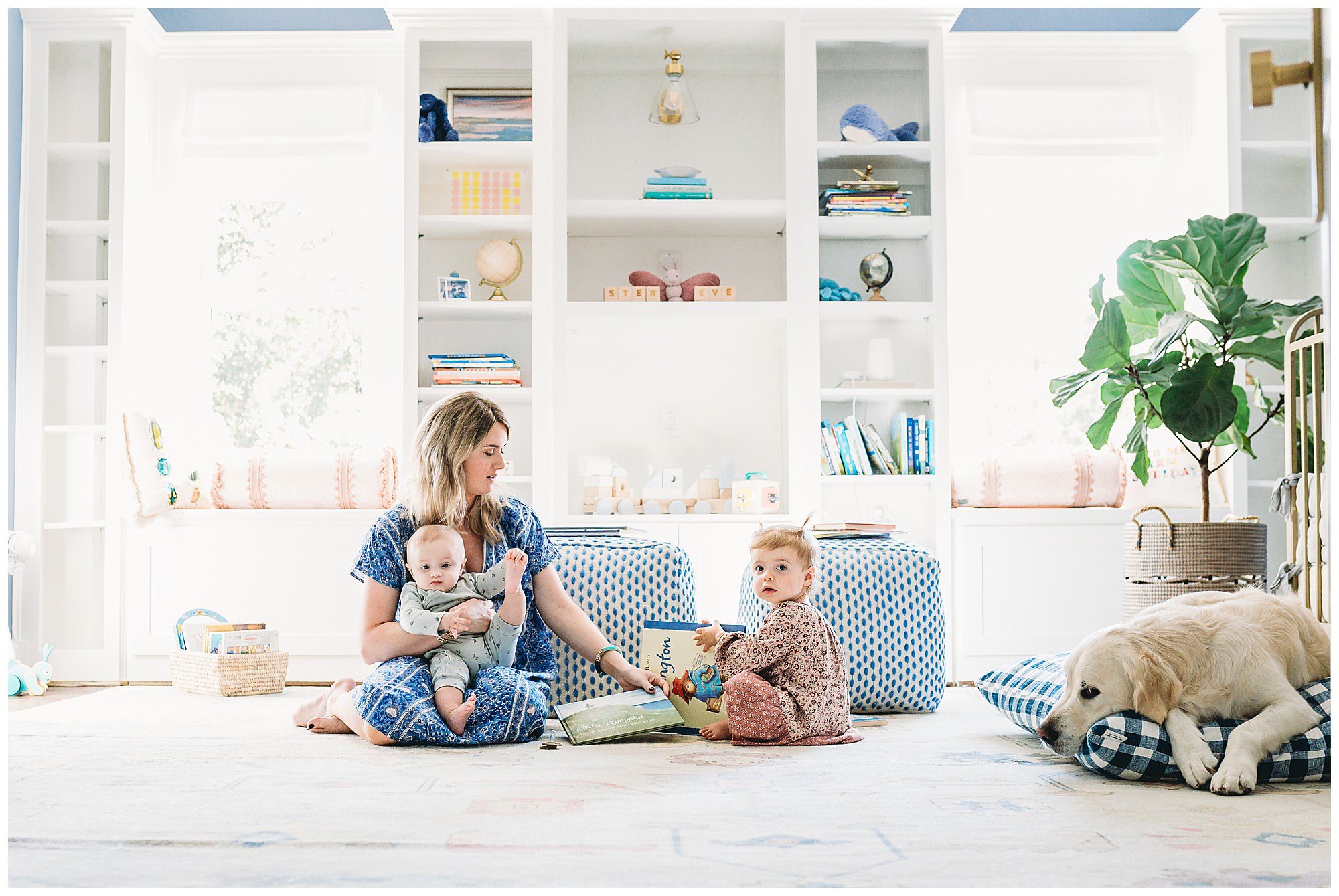 Mother with two children in nursery at home with dog