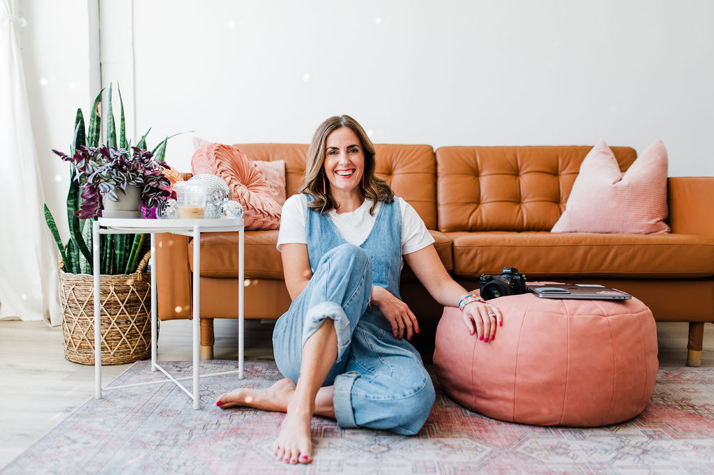 photographer sitting near a couch discussing how to get photography clients