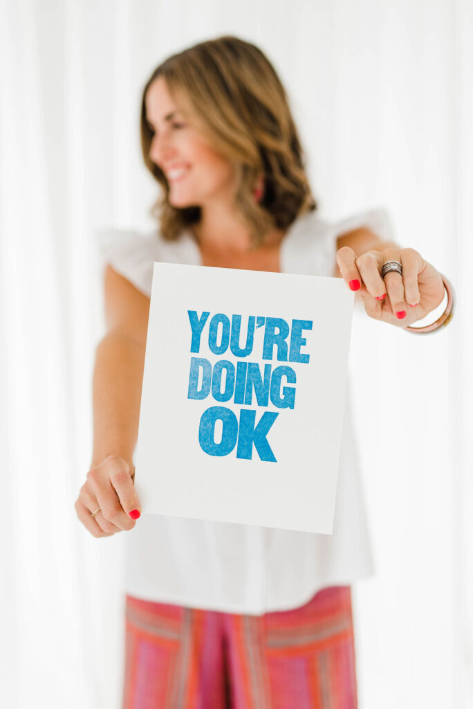 photographer holding up a sign ready to talk to photographers about how to build a photography portfolio 