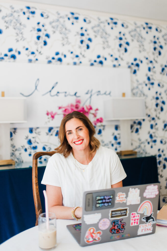 Photography Website Mistakes (and How to Fix Them) 1 photography coach sitting at her desk ready to talk about your photography website and how to make some quick adjustments to bring in more clients
