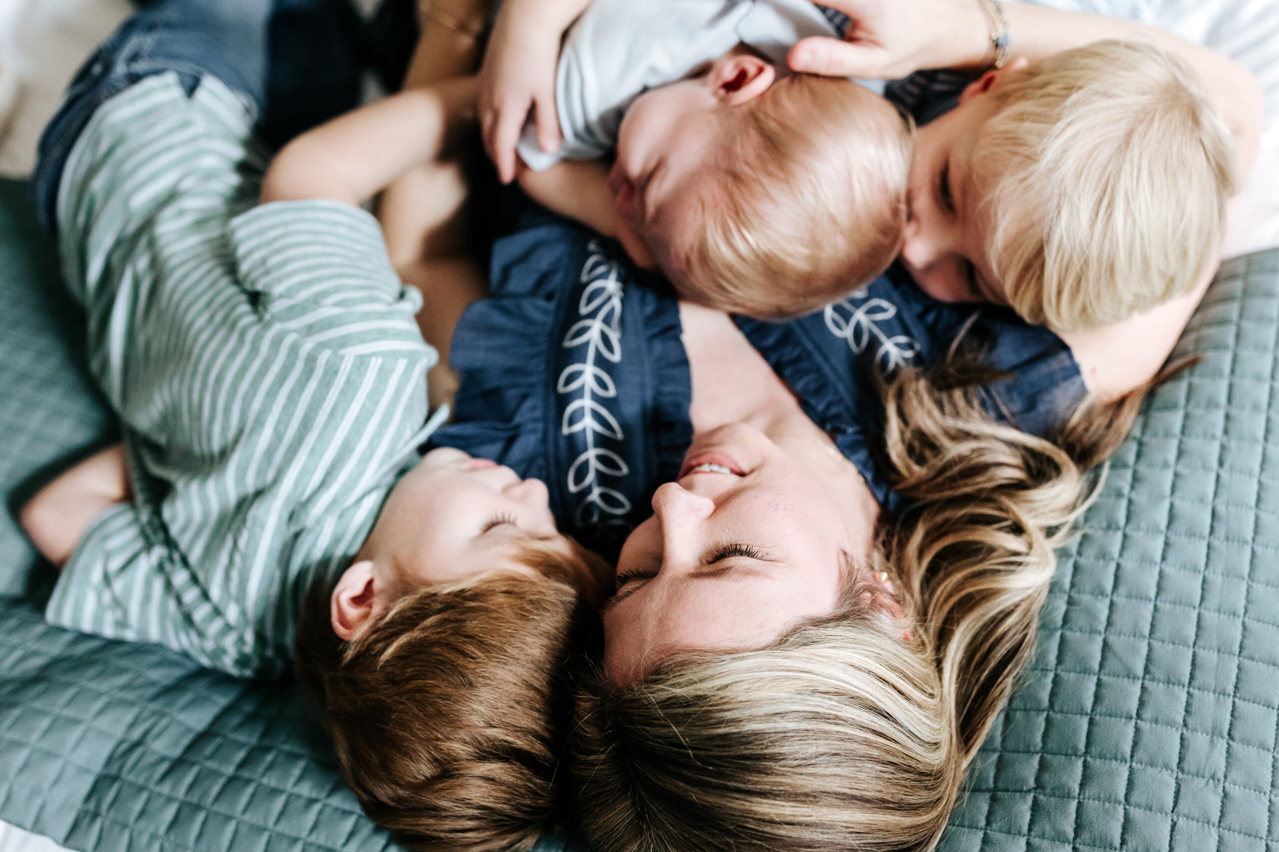 Photographer FAQ: "Can You Just Photograph the Kids?" (Here's My Take) 2 A tender family moment of a mother cuddling her children, illustrating the heart behind this photographer FAQ about including parents in photos.
