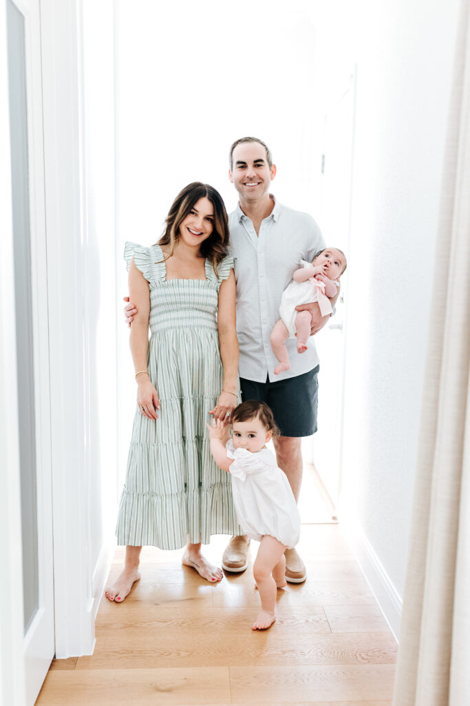 Photographer FAQ: "Can You Just Photograph the Kids?" (Here's My Take) 3 Bright, joyful image of a young family standing together, echoing the answer to a popular photographer FAQ about not leaving parents out of photos.