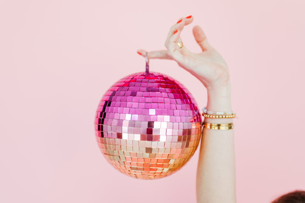 Flodesk Review: The Email Marketing Platform I Actually Use and Love 3 Hand holding a pink disco ball with gold accents—capturing the fun, vibrant tone of this Flodesk review for creatives.