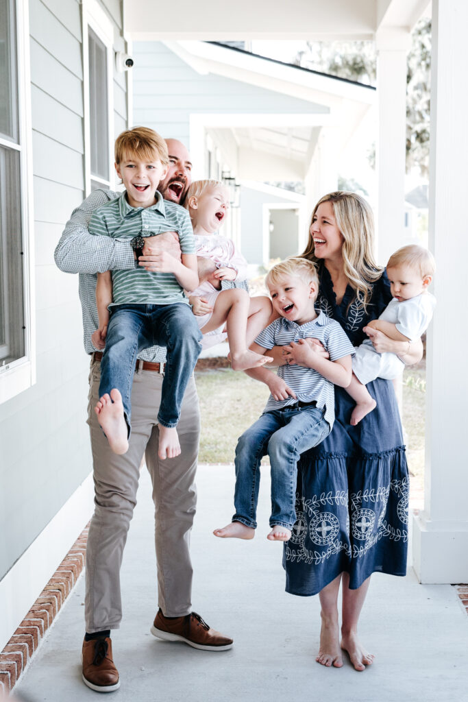 Family Photo Shoot Tips: A Parent’s Guide to Easy, Joyful Photo Sessions 3 A joyful moment during a front porch session, showcasing real-life connection and laughter—perfect example of family photo shoot tips in action.