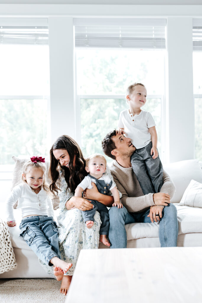 Family Photo Shoot Tips: A Parent’s Guide to Easy, Joyful Photo Sessions 2 A cozy family moment on the couch with natural light, highlighting relaxed posing and real connection—ideal for family photo shoot tips.