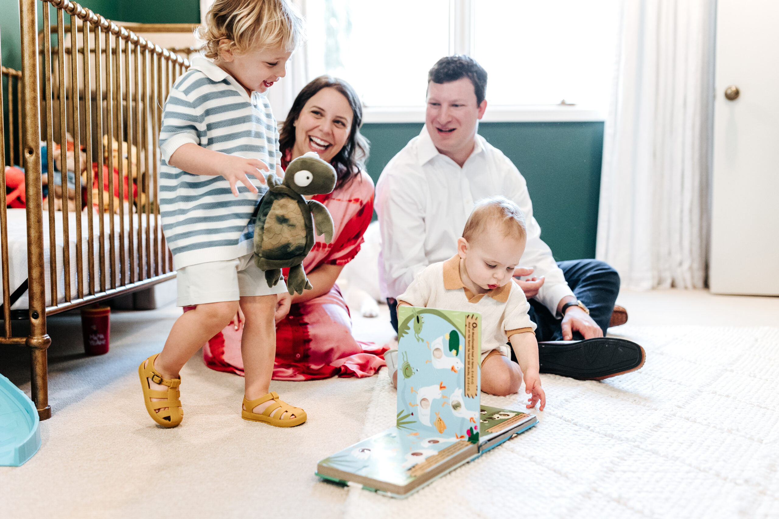 Candid nursery moment with kids playing and parents smiling, demonstrating how family photo shoot tips support comfort and ease at home.