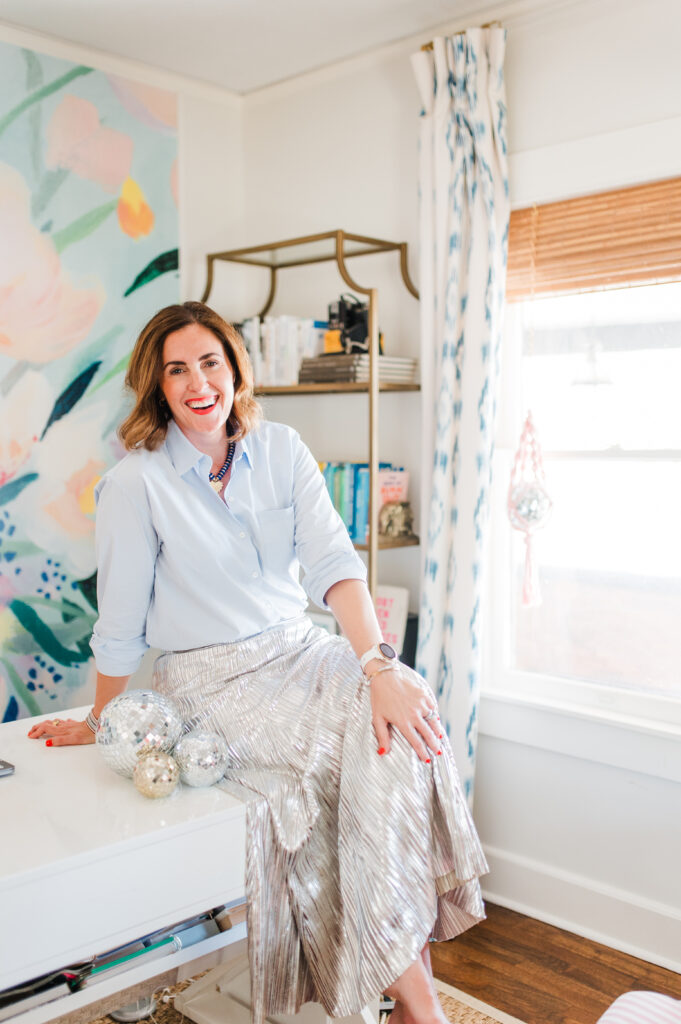 Raise Your Prices With Confidence: How to Know When It’s Time (and Do It Without Guilt) 3 Creative entrepreneur Sabrina Gebhardt smiling in her office, inspiring photographers to raise your prices and build a business that supports your life.