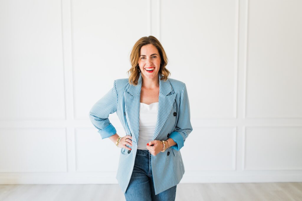 Woman smiling confidently in a bright studio, reflecting growth and clarity after correcting pricing mistakes photographers make.