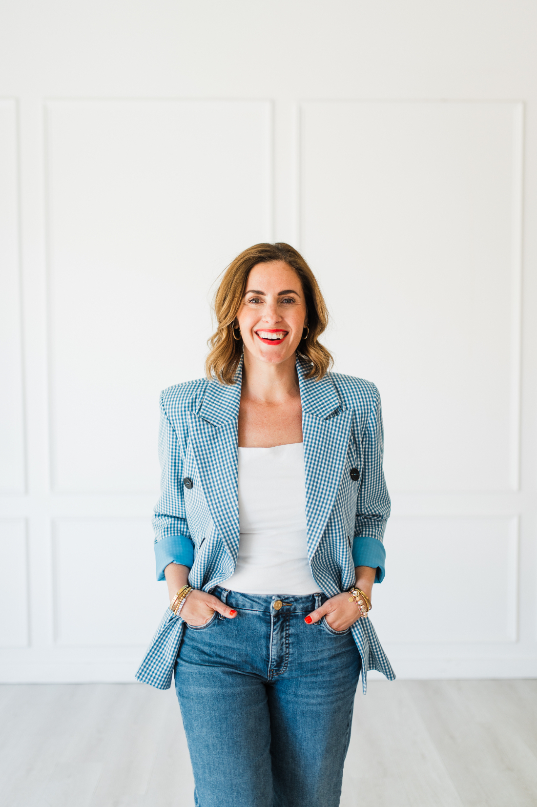 Confident photographer in a bold blazer, showcasing personality and professionalism through her photography style.