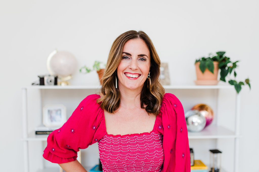 Portrait of creative entrepreneur smiling in studio while building a photography business she loves