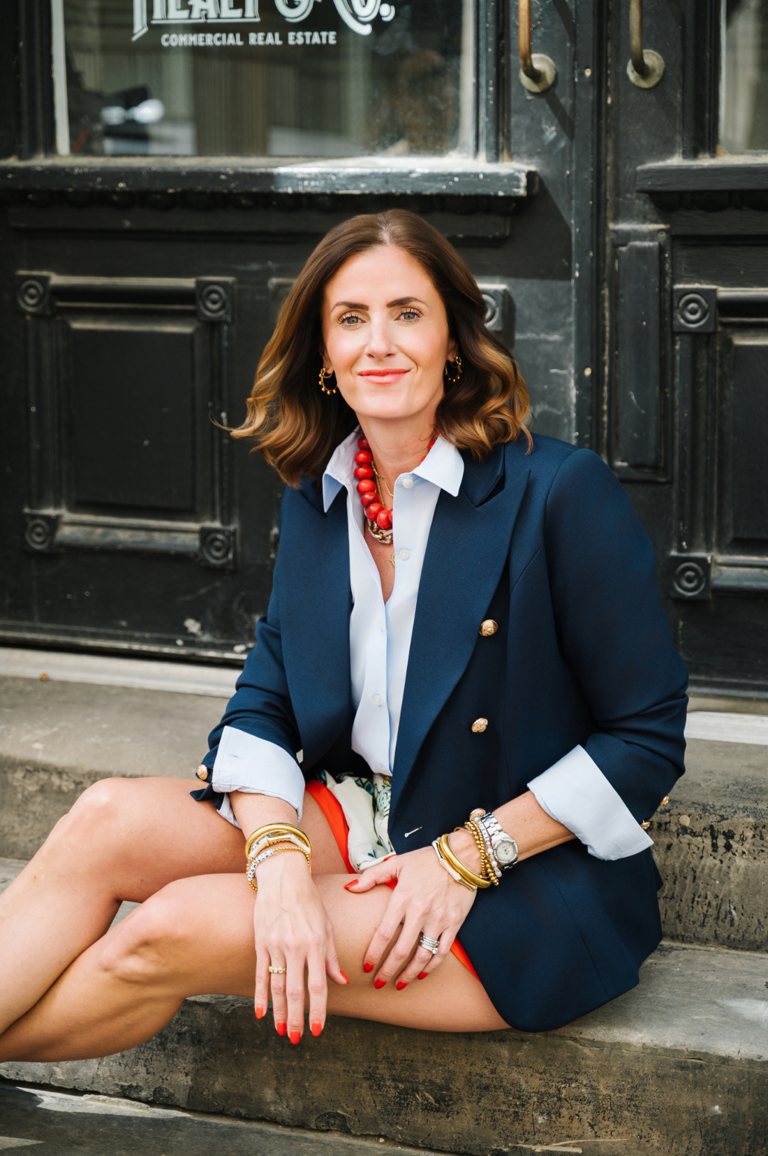 Photography Business Setup: How to Build a Business That Supports Your Life 1 Photographer sitting outside in a navy blazer, representing a thoughtful photography business setup for long term success.